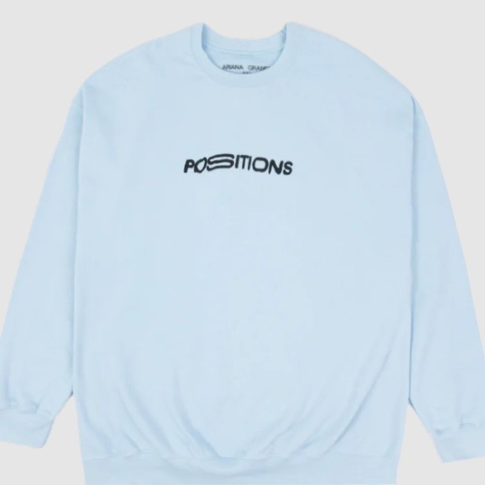 Ariana Grande positions baby blue sweatshirt